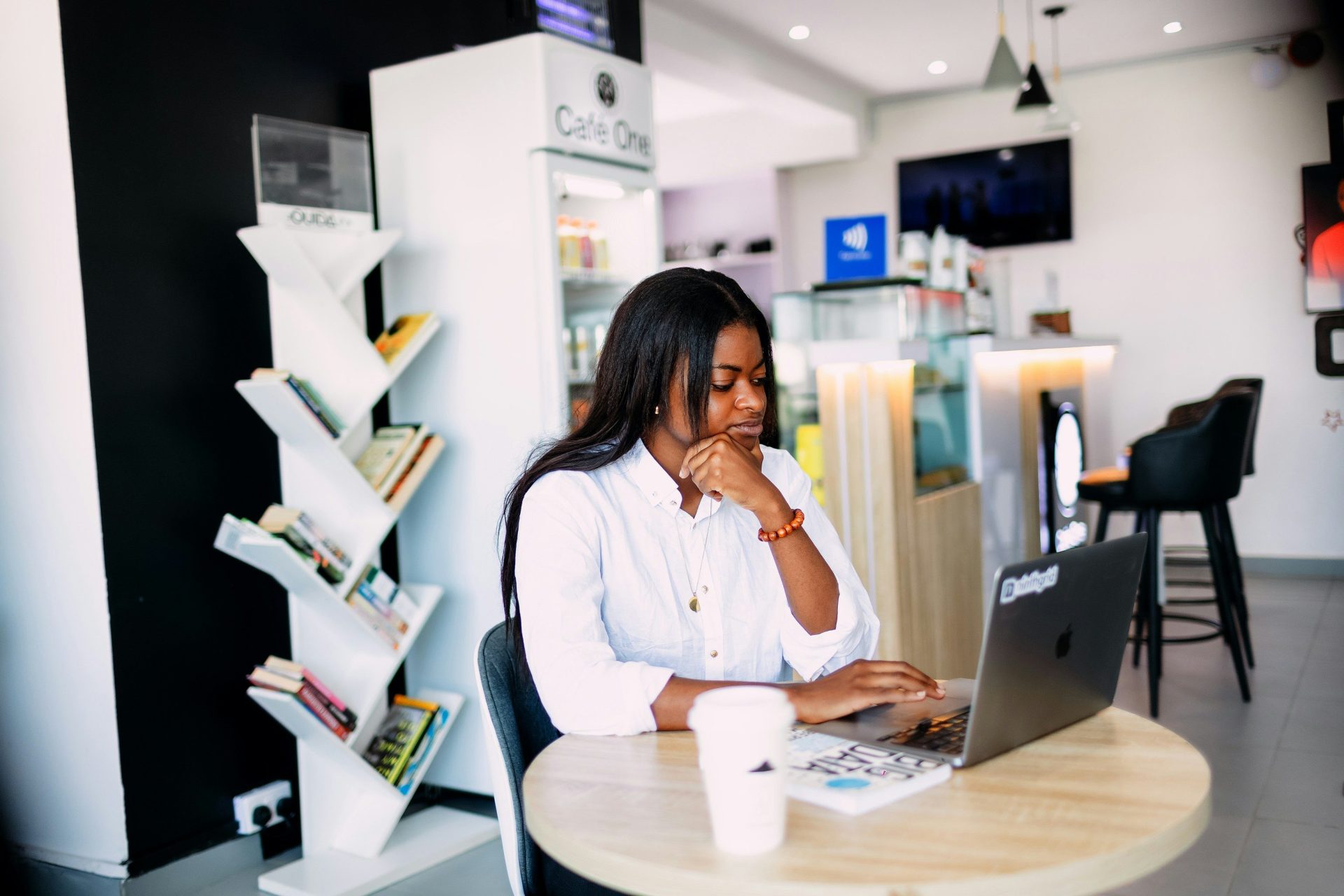 A woman sitting at a table with a laptop
